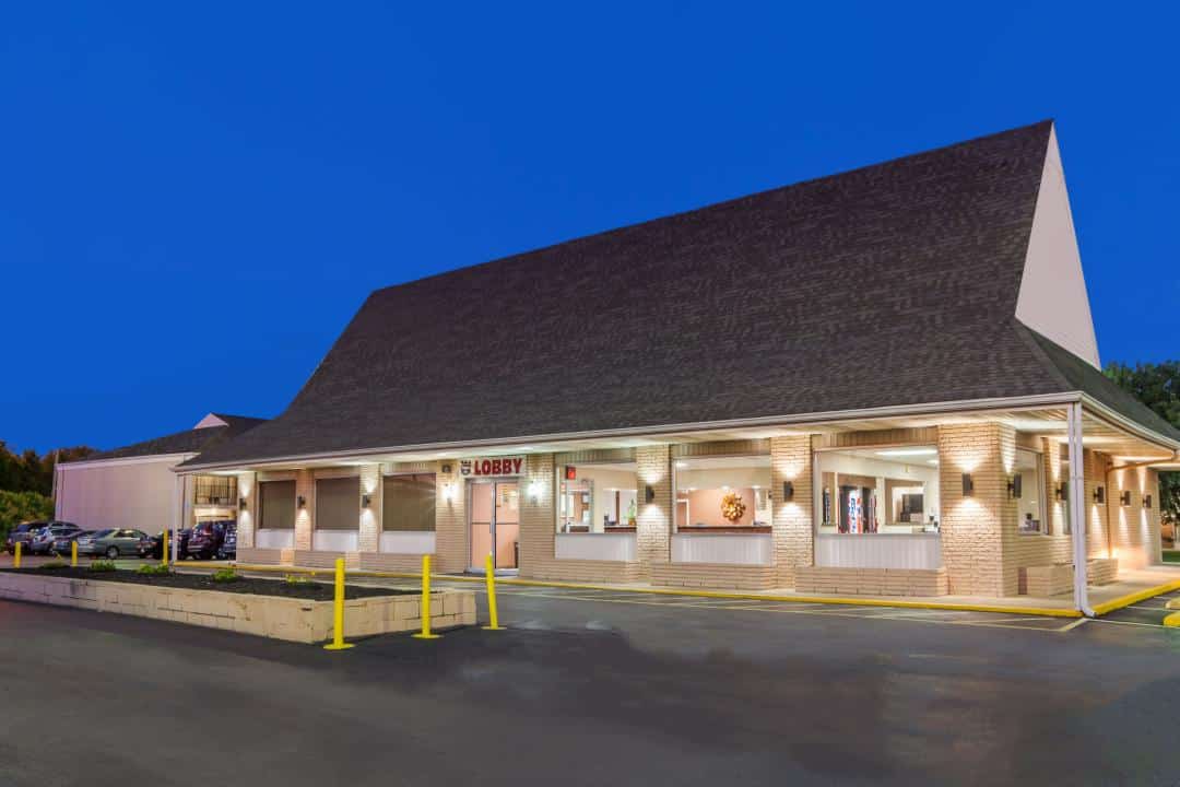 Hotel exterior at night.