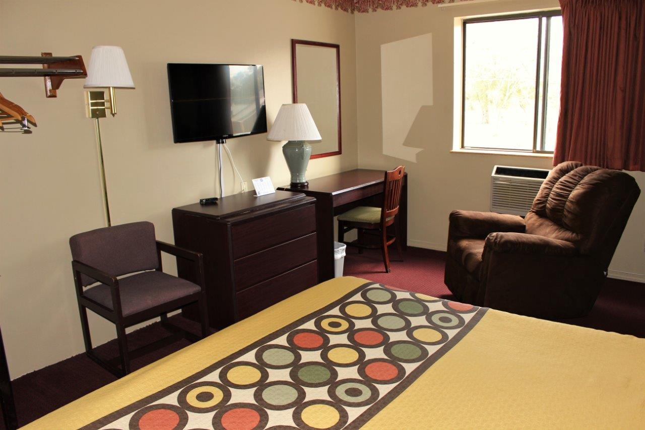 Hotel room TV and seating area.