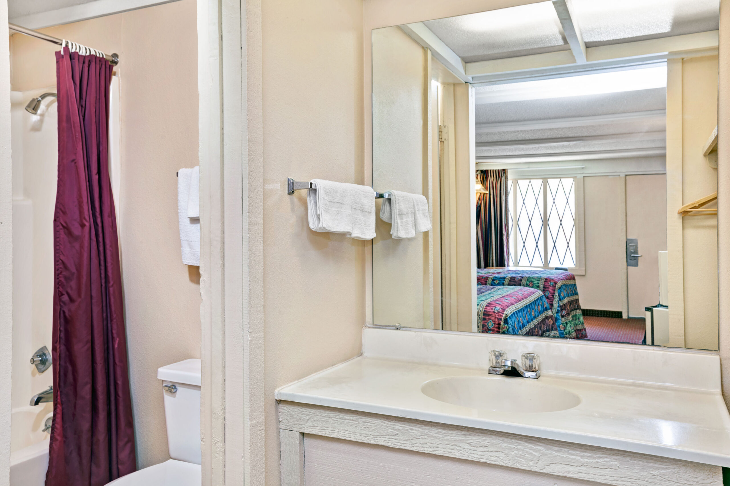 Bathroom vanity with mirror in hotel room.
