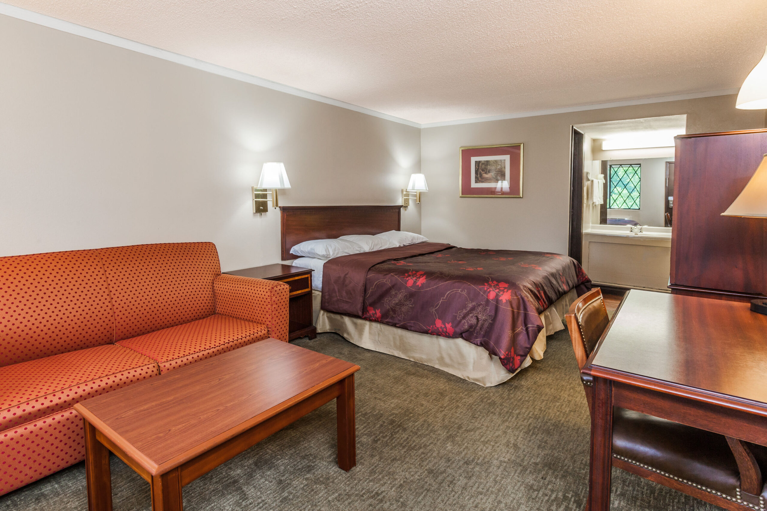 Hotel room with a double bed with a seating area.