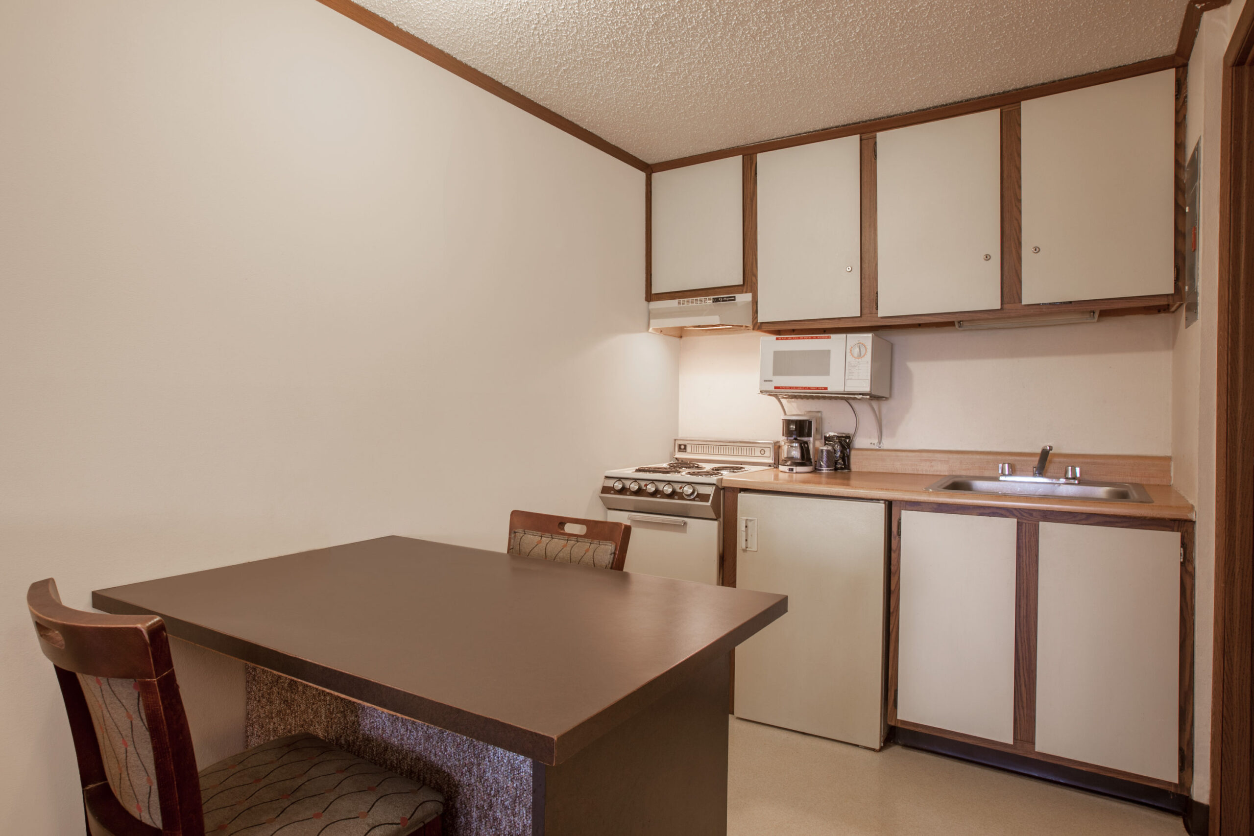 Hotel room work area and kitchenette.