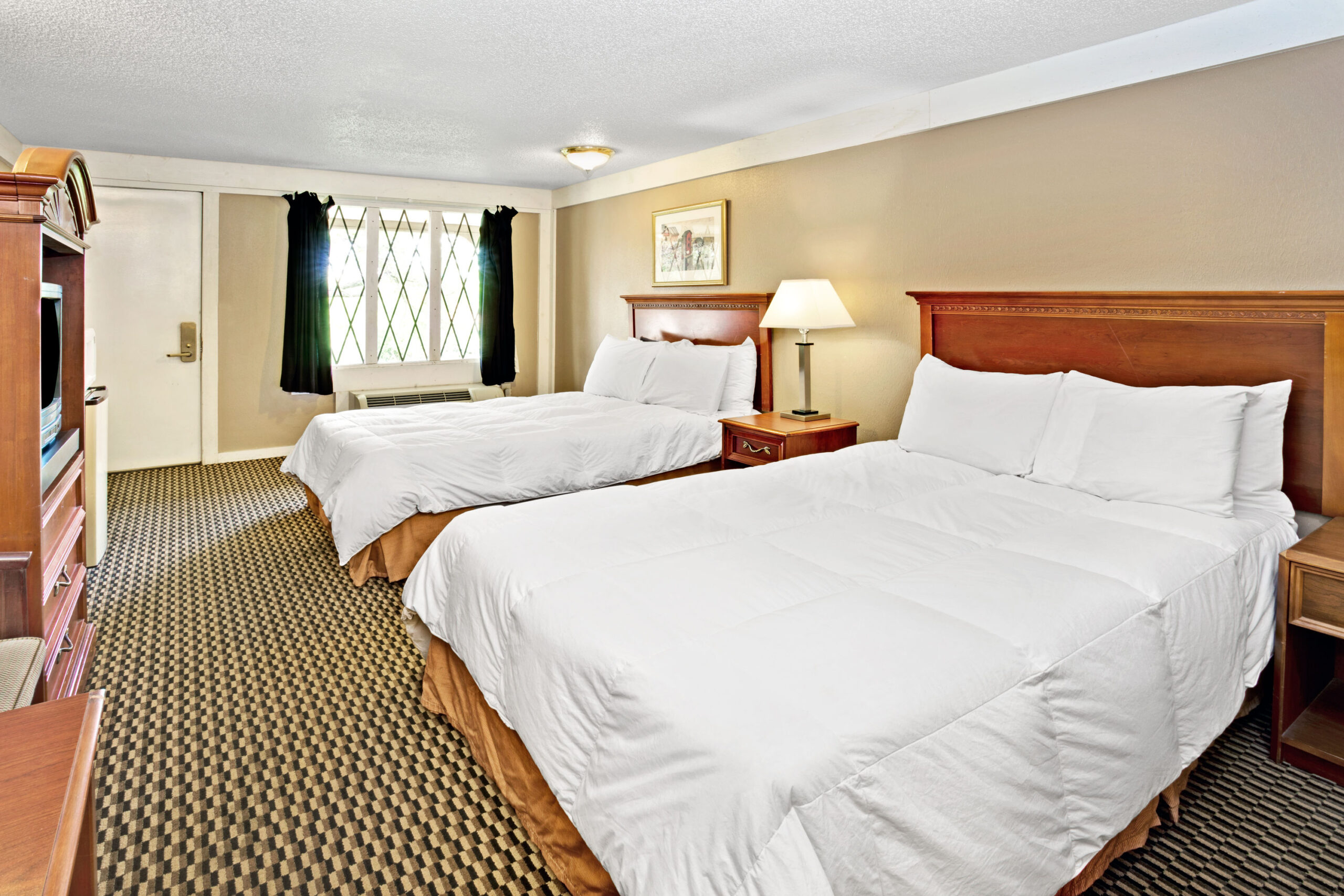 Hotel room with two double beds.