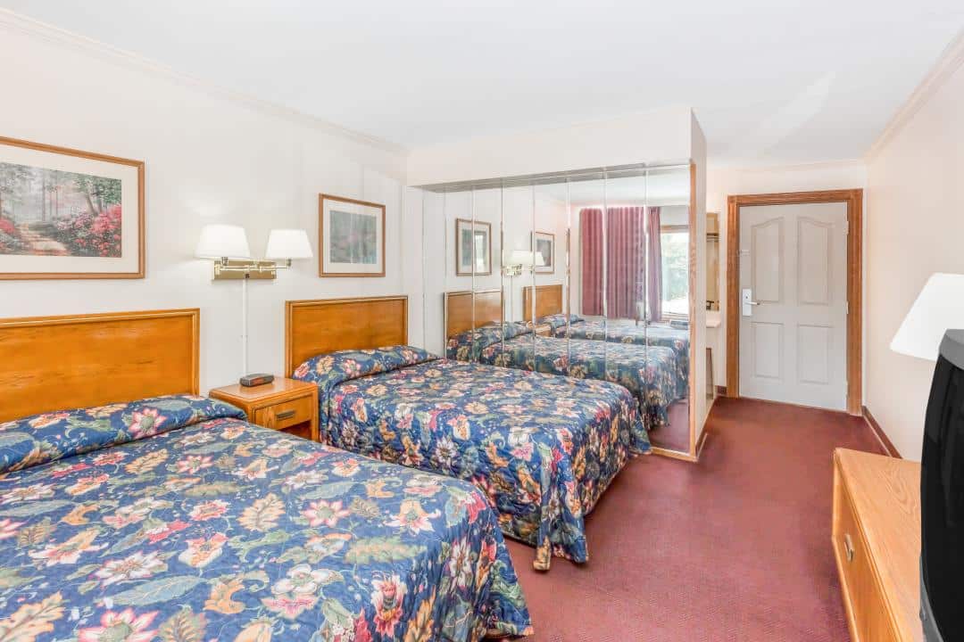 Hotel room with three beds.