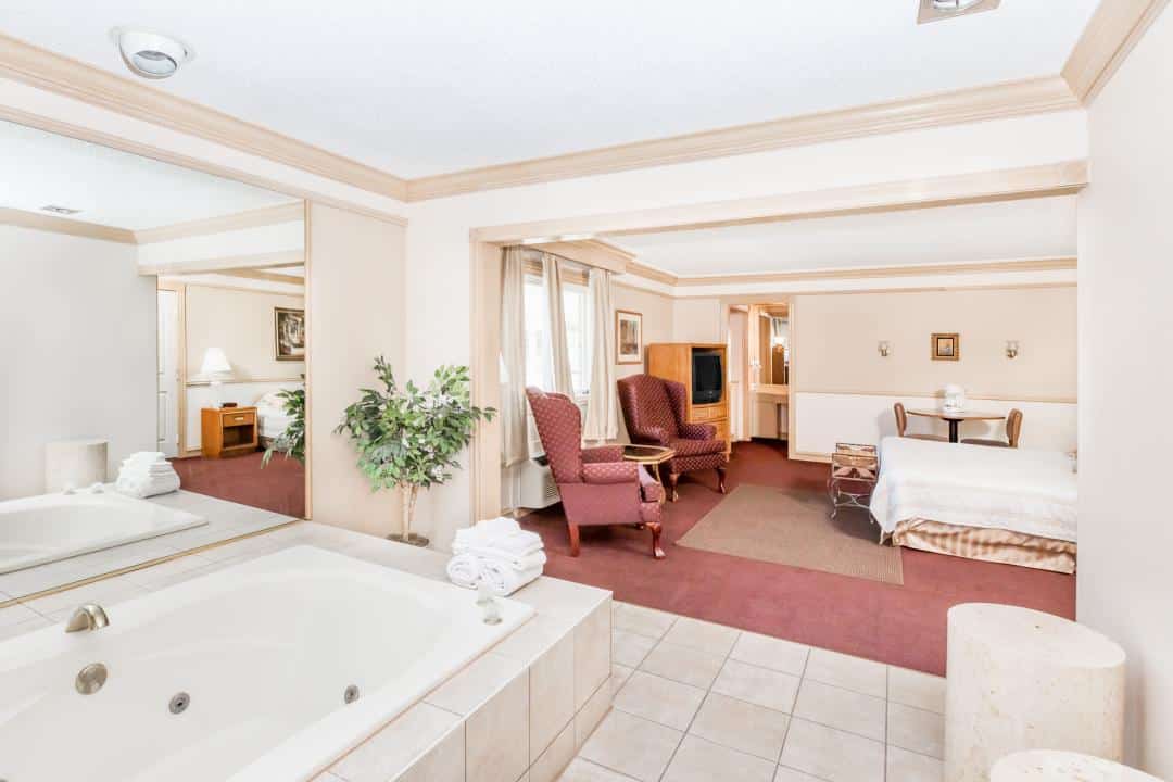 Hotel room with a king bed and a seating area.