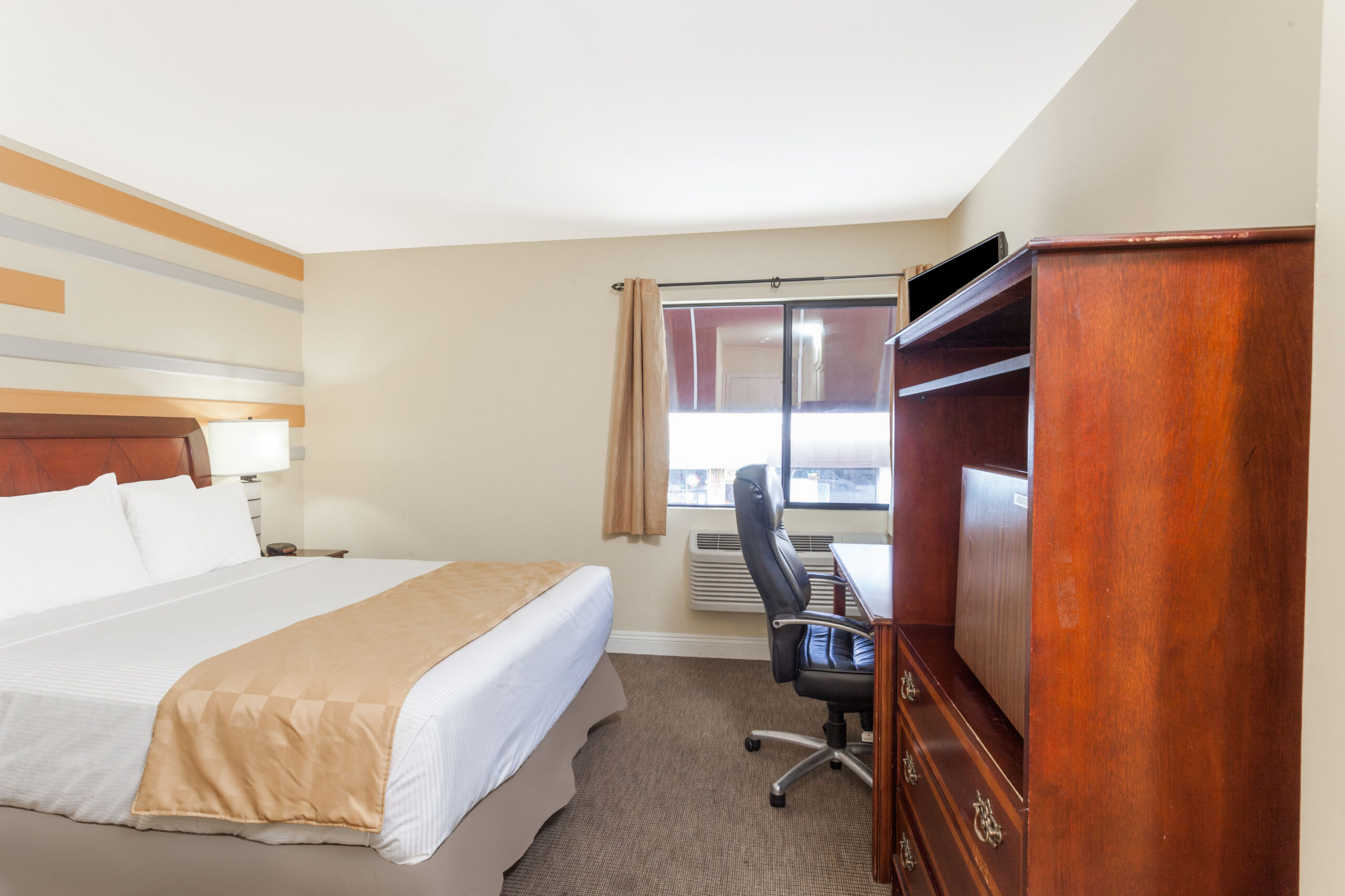 Hotel room with a work area.