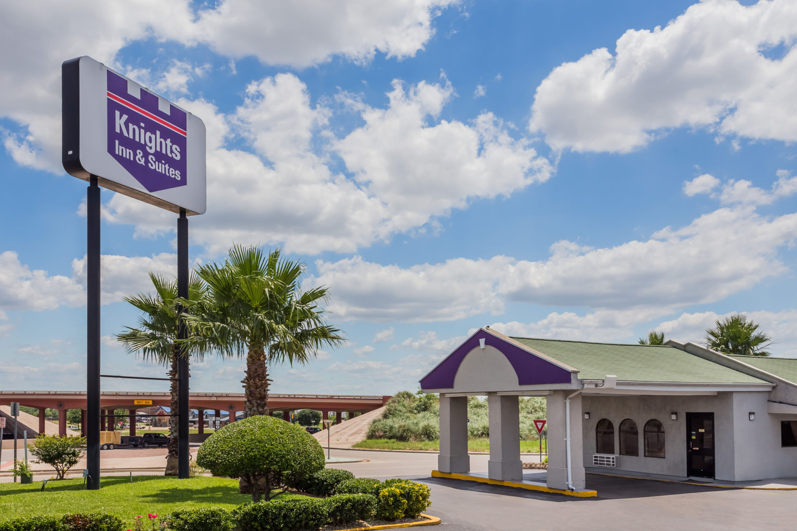 Hotel exterior with knights inn sign during daylight.