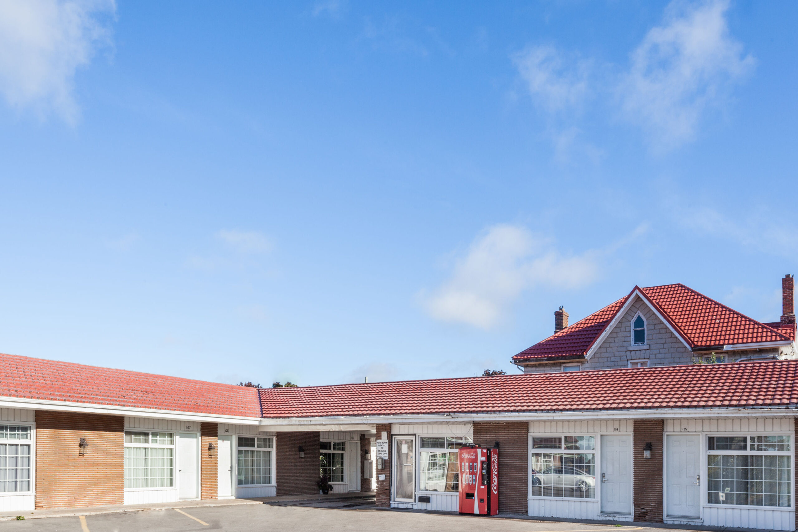 The exterior of a Knights Inn motel with a sign visible, featuring a red-roofed building and a parking lot.