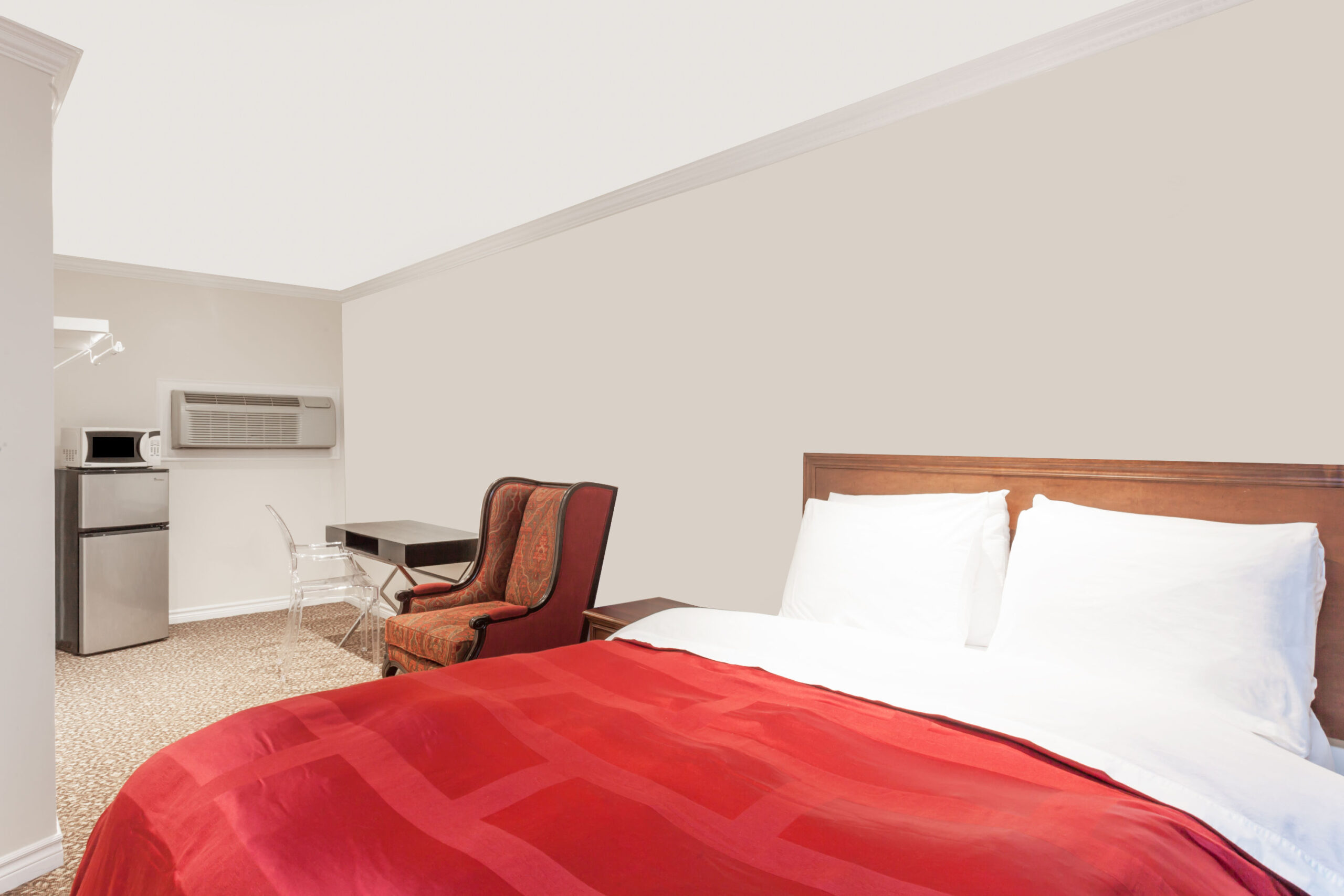 Single bed with red bedding.