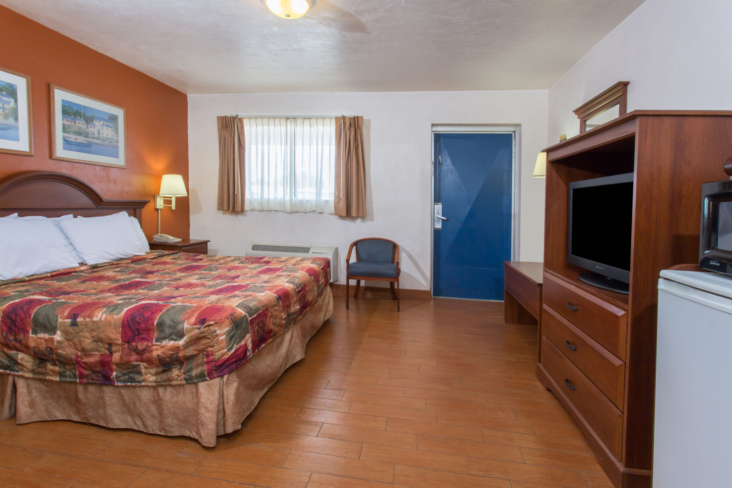 Hotel room with a double bed and TV.