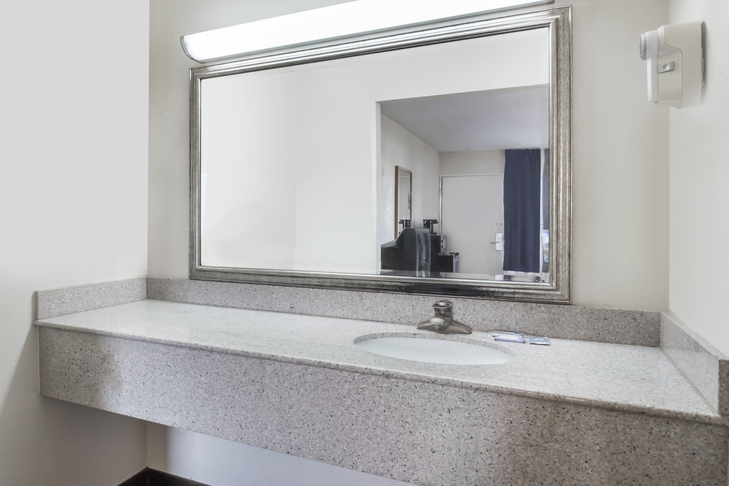 Bathroom vanity with large mirror and countertop.