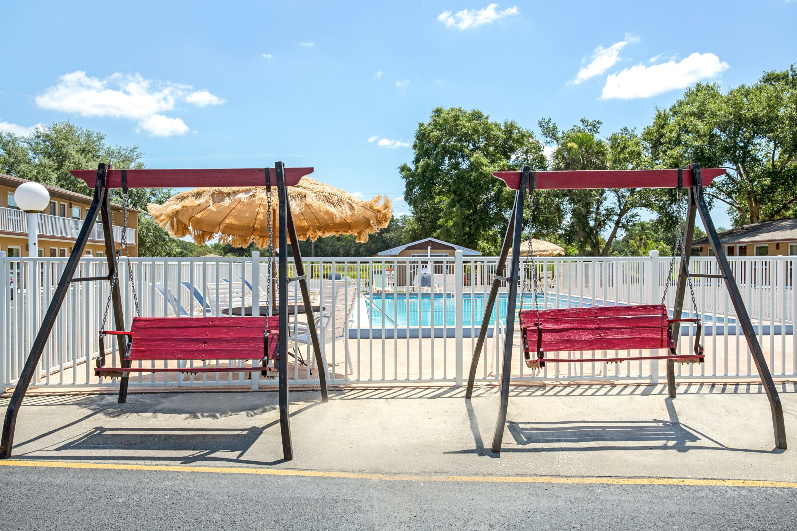 Hotel pool area with swings.