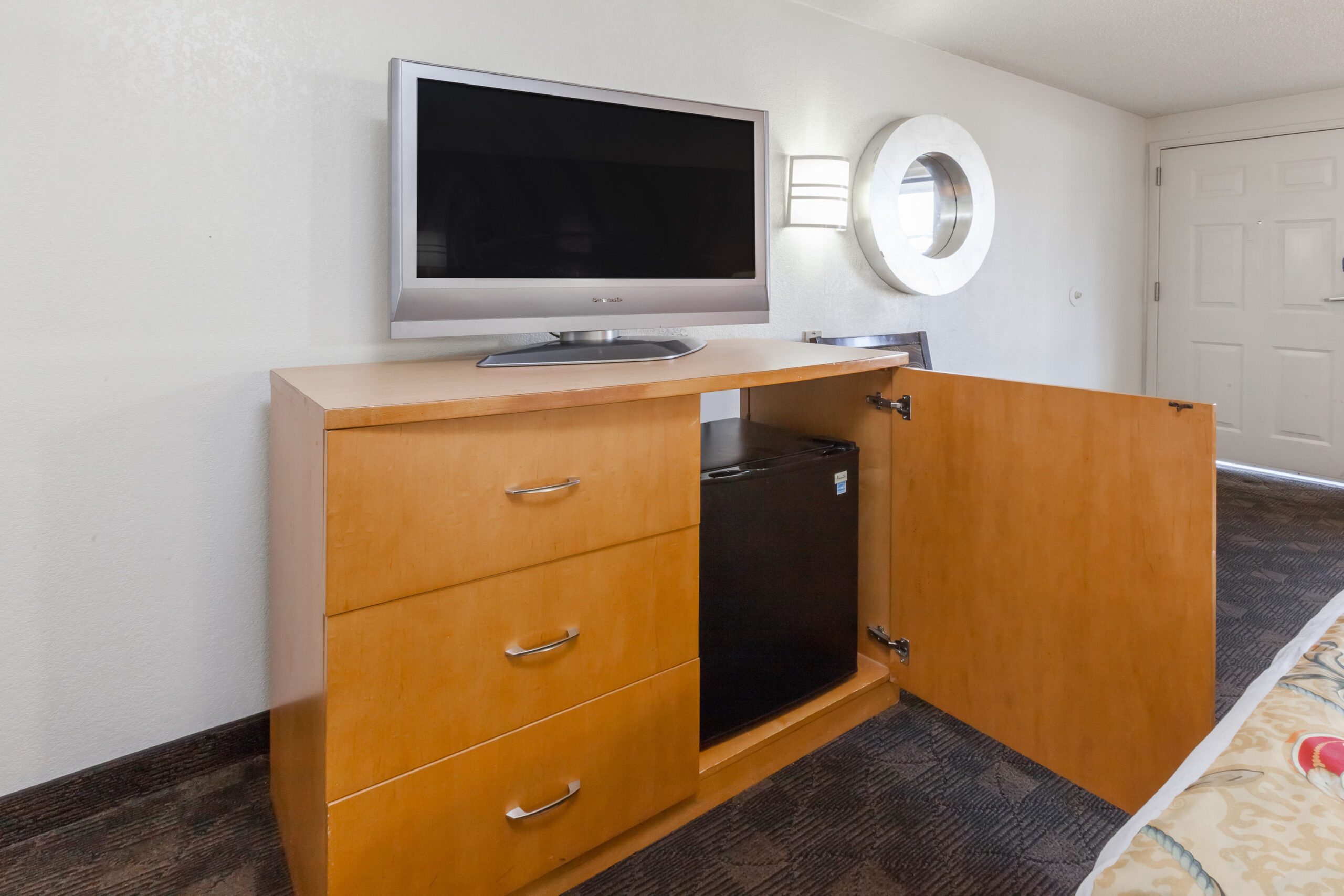 Hotel room TV and seating area.