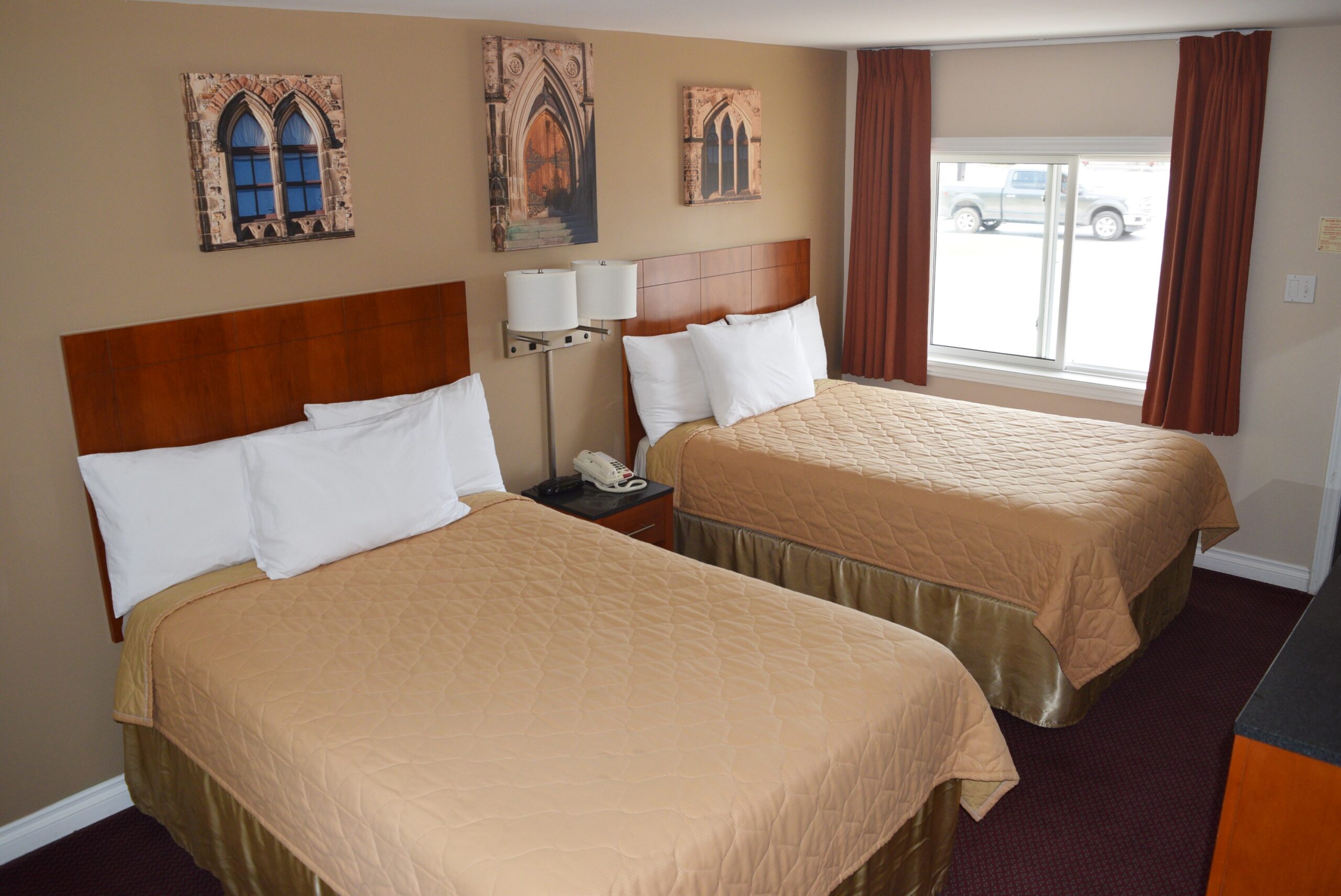 Hotel room with two beds and a window.