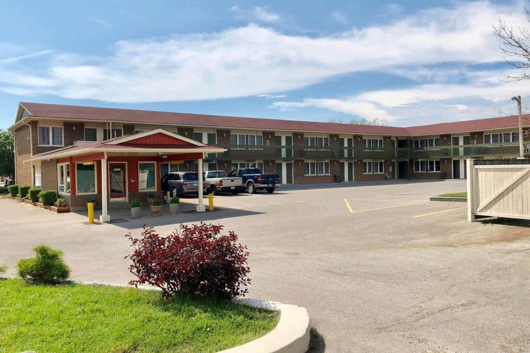 Exterior of a two-story motel building with parking.