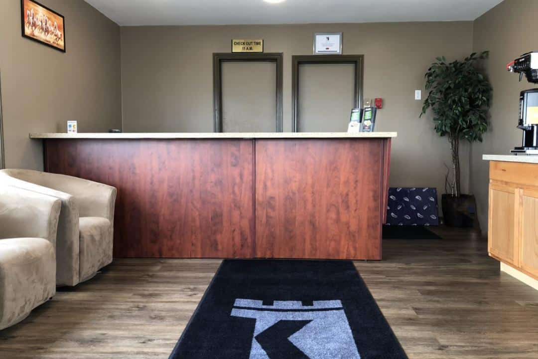Hotel front desk with dark wood finish.