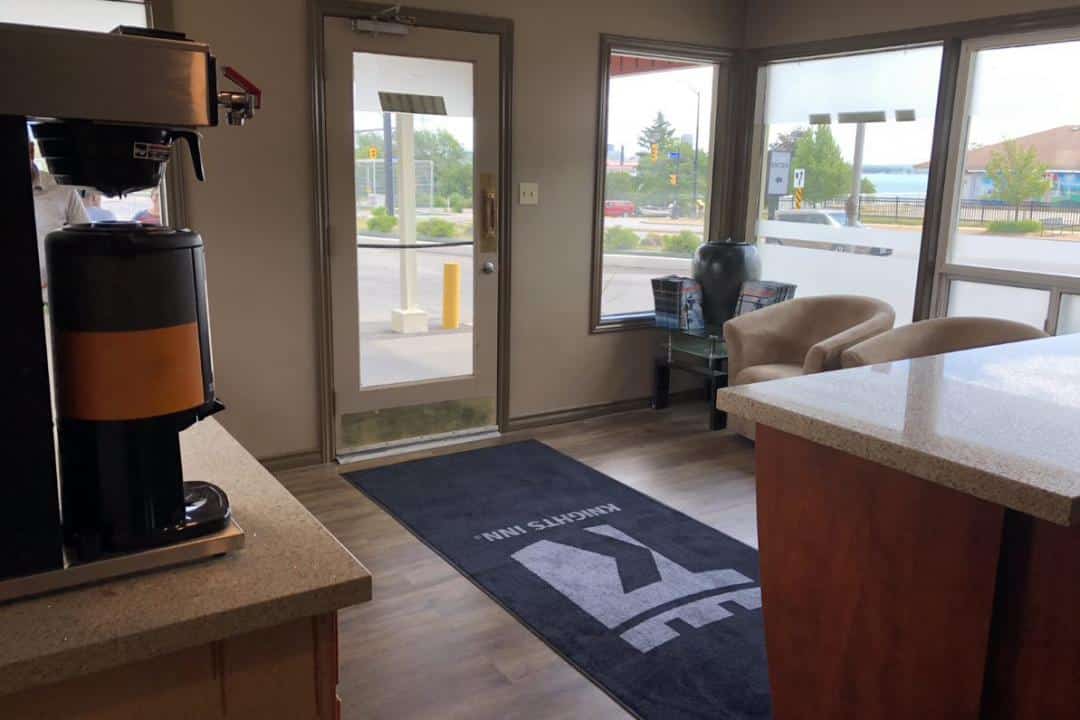 Hotel lobby with coffee station and seating.