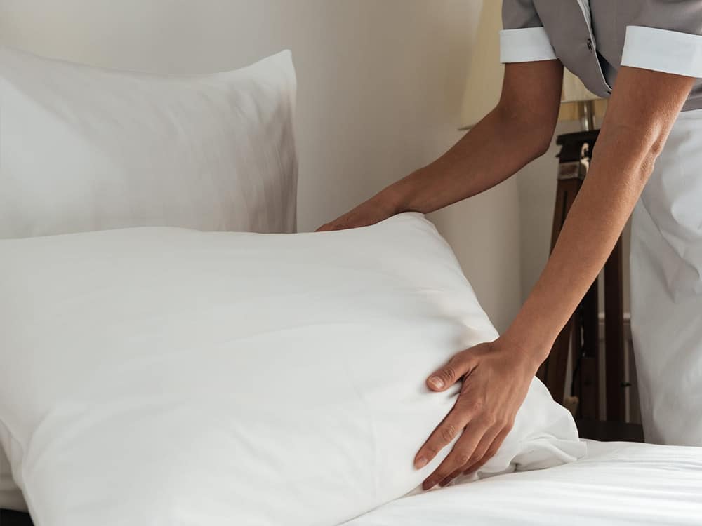 Housekeeping lady arranging pillows